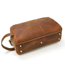 Cargar imagen en el visor de la galería, The Wanderer Toiletry Bag | Genuine Leather Toiletry Bag in brown leather with handle and rivet details, perfect for travel organization.