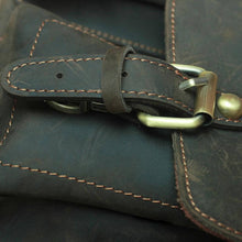 Load image into Gallery viewer, Close-up of The Faust Leather Camera Bag buckle, showcasing handcrafted full-grain leather of the Crossbody Vintage Camera Messenger Bag.