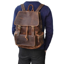 Charger l'image dans la galerie, The Hagen Backpack | Vintage Leather Backpack on person's back, featuring genuine cowhide leather, versatile design, durable and stylish.