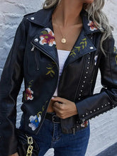 Load image into Gallery viewer, Woman wearing a floral print faux leather jacket with studded details, combining punk rock style with romantic elegance.