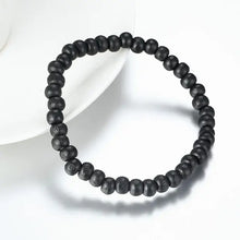 Cargar imagen en el visor de la galería, Minimalist black beaded bracelet on a white background, showcasing stylish simplicity and versatility for casual or elegant wear.