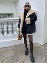 Load image into Gallery viewer, Model wearing Cozy Chic Bomber Jacket with faux wool patchwork, vegan leather, fur liner, and stylish lapel outdoors.