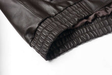 Load image into Gallery viewer, Close-up of the elastic cuff on a REED Men's genuine leather bomber jacket, showing detailed craftsmanship and luxurious material.