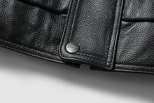 Load image into Gallery viewer, Close-up of REED Men's genuine leather bomber jacket showing detailed texture and branded button, showcasing craftsmanship.