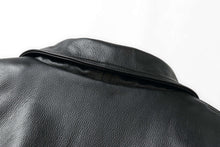 Load image into Gallery viewer, Close-up of black genuine leather on REED Men's American Style Bomber Jacket, showcasing texture and craftsmanship.