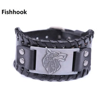 Load image into Gallery viewer, Vintage wide leather bracelet with a woven design and wolf head emblem showcasing strength and style.