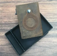 Load image into Gallery viewer, Minimal leather credit card holder on a wooden table, showcasing sleek design and premium quality in an open black box.