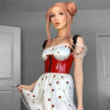 Load image into Gallery viewer, Woman in white dress with red corset and rose pattern, standing in a room with her hair styled in buns.