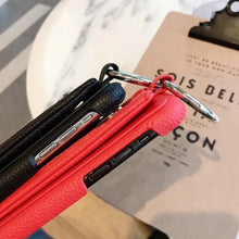 Cargar imagen en el visor de la galería, Close-up of luxury zipper PU leather wallet cases in black and red, designed for iPhone models, showcasing elegance and functionality.
