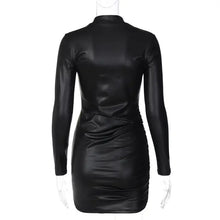 Load image into Gallery viewer, Back view of black faux leather ruched mini dress with long sleeves and sleek design.