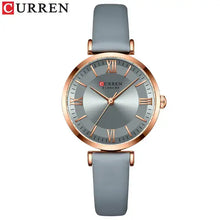 Cargar imagen en el visor de la galería, Classic Clock Leather Watch for women with elegant grey leather strap and gold-tone clockface, featuring water-resistant quartz movement.