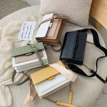 Cargar imagen en el visor de la galería, Assorted designer leather crossbody shopping bags in four colors: black, green, yellow, and brown, displayed on a chair.