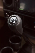 Load image into Gallery viewer, Leather gear knob kit for enhancing driving comfort and style in a car interior.