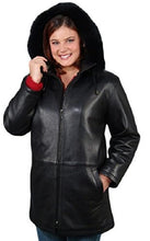 Cargar imagen en el visor de la galería, Woman wearing black REED 33-inch leather parka with fox-trimmed detachable hood, showcasing style and comfort.