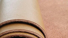 Cargar imagen en el visor de la galería, Close-up of rolled leather hides in various colors, ideal for leather crafts and garments. Durable cow hides measuring 8 x 11 inches.