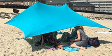 Charger l'image dans la galerie, eZthings UV Light Sun Shade Protection Beach Shelter with sandbag anchors, offering sun protection, set up on a sandy beach.