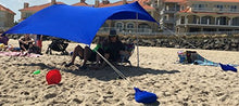 Charger l'image dans la galerie, Royal blue UV sun shade beach shelter with sandbag anchors, providing sun protection and air circulation for beachgoers.