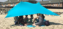 Charger l'image dans la galerie, Group enjoying shade under eZthings UV light beach shelter with sandbag anchors on a sunny beach.