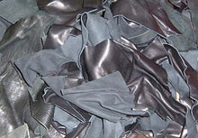 Load image into Gallery viewer, Pile of black leather scraps from garment cutting for crafts and arts projects, showcasing cowhide remnants from high-quality jackets.