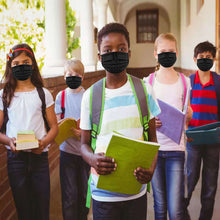 Cargar imagen en el visor de la galería, Kids wearing black face masks holding books in a school corridor.