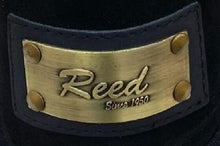 Cargar imagen en el visor de la galería, Close-up of Reed brand metal label on leather product, showcasing antique finish and craftsmanship.