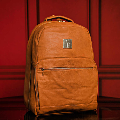 Brown tumbled leather commuter backpack with spacious capacity for laptop, shoes, and clothes. TSA approved, water-resistant carry-on.