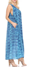 Charger l&#39;image dans la galerie, Woman wearing a blue patterned sleeveless maxi dress with pockets, ideal for summer or as a cover-up, shown in side view.
