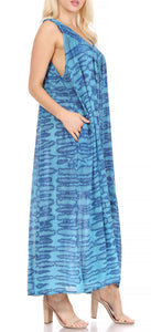 Woman wearing a blue patterned sleeveless maxi dress with pockets, ideal for summer or as a cover-up, shown in side view.