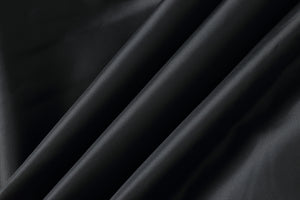 Close-up of black genuine leather fabric with smooth texture, perfect for men's bomber jackets.