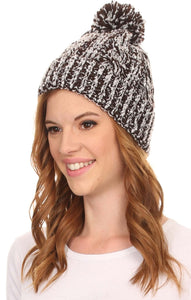 Model wearing Greer Unisex Heathered Textured Knit Pom Pom Beanie Hat in brown and white, showcasing its stylish design and large pom pom.