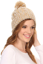 Cargar imagen en el visor de la galería, Model wearing a Greer unisex heathered textured knit pom pom beanie hat in a warm gold color.
