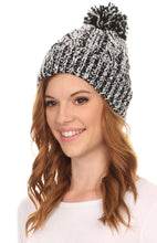 Cargar imagen en el visor de la galería, Model wearing a Greer unisex heathered textured knit pom pom beanie hat in black and white.
