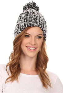 Woman wearing Greer unisex heathered texture knit pom pom beanie hat in black and white.