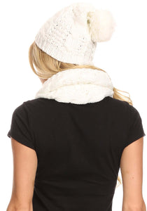 Woman wearing Haile Metallic Threaded Woven Classic Hat Beanie and Infinity Scarf Set in white, showing back view with pom pom detail.
