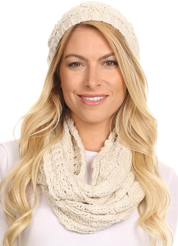 Model wearing Haile metallic threaded woven beanie and infinity scarf set in classic knit design with pom pom top.