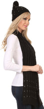 Charger l&#39;image dans la galerie, Woman wearing Kae Jewel Studded Cable Knit Beanie Hat and Scarf Set in black. Soft acrylic fabric with pom pom detail on the hat.
