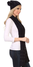 Charger l&#39;image dans la galerie, Woman wearing Kae Jewel Studded Cable Knit Beanie Hat and Scarf Set in black with pom pom, showcasing soft acrylic fabric and slouchy fit.
