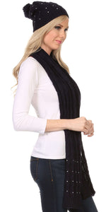 Woman wearing Kae Jewel Studded Cable Knit Beanie Hat and Scarf Set in black with pom pom, showcasing soft acrylic fabric and slouchy fit.