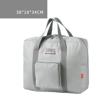 Load image into Gallery viewer, Large capacity foldable canvas travel bag for men and women, 38x18x34cm, in light grey with a front pocket.

