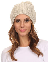 Charger l&#39;image dans la galerie, Unisex cable knit beanie hat with large pom pom, shown on model; features a snug fit with slouchy style for varied hair volumes.
