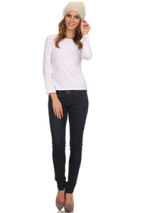 Woman wearing Lax Wide Cable Knit Pom Pom Beanie Hat in cream, styled with white top and jeans, showcasing slouchy fit and texture.