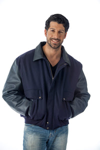 Man wearing a REED leather varsity bomber jacket, showcasing top grain leather sleeves and collar, made in USA.