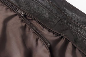 Close-up of REED men's bomber jacket showcasing genuine leather texture with detailed zippers and lining.