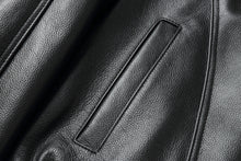 Load image into Gallery viewer, Close-up of REED Men&#39;s American Style Bomber Genuine Leather Jacket showcasing black leather texture and sleek stitching details.

