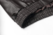 Load image into Gallery viewer, Close-up of the elastic cuff on a REED Men&#39;s genuine leather bomber jacket, showing detailed craftsmanship and luxurious material.
