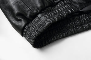 Close-up of REED Men's bomber jacket elastic hem in genuine leather