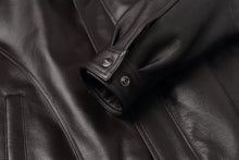 Load image into Gallery viewer, Close-up of REED Men&#39;s American Style Bomber Jacket in genuine leather showcasing luxurious texture and quality craftsmanship.
