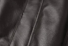 Load image into Gallery viewer, Close-up of REED Men&#39;s genuine leather jacket featuring a sleek, luxurious surface with a classic American bomber design.
