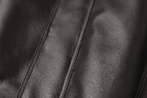 Close-up of REED Men's genuine leather jacket featuring a sleek, luxurious surface with a classic American bomber design.