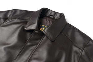 REED Men's American Style Bomber Genuine Leather Jacket, close-up of black leather material and collar design.